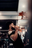 A man holding a bar in a gym