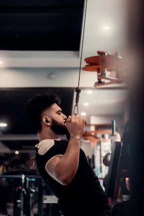 A man holding a bar in a gym