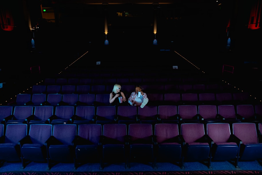 A couple of people sitting on top of a stage