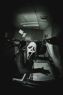 A black and white photo of a person wearing a mask