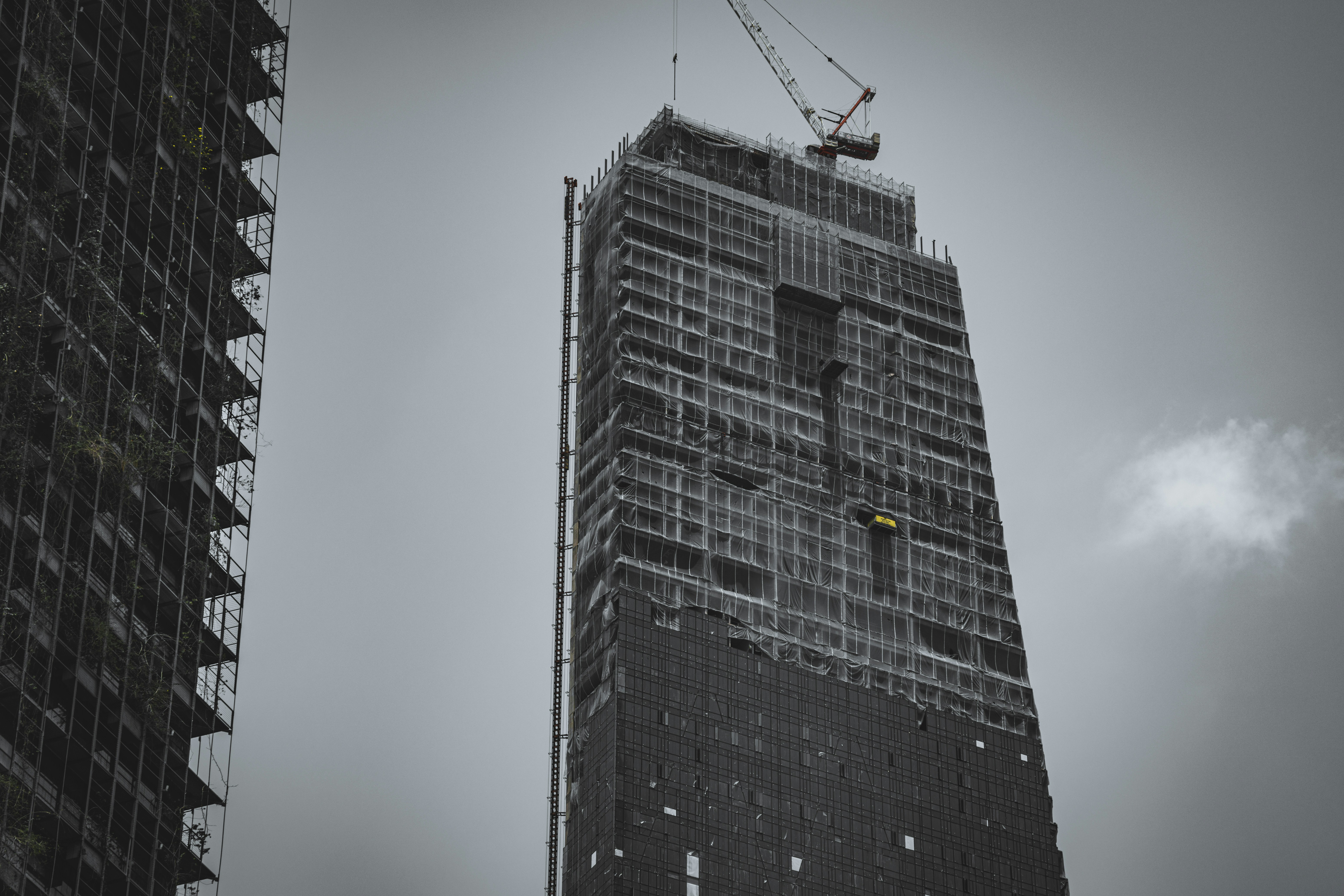A very tall building with a crane on top of it