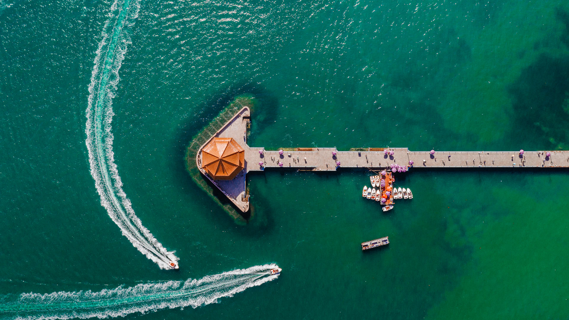 An aerial view of a pier and boats in the water