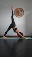 A woman is doing a yoga pose on a mat
