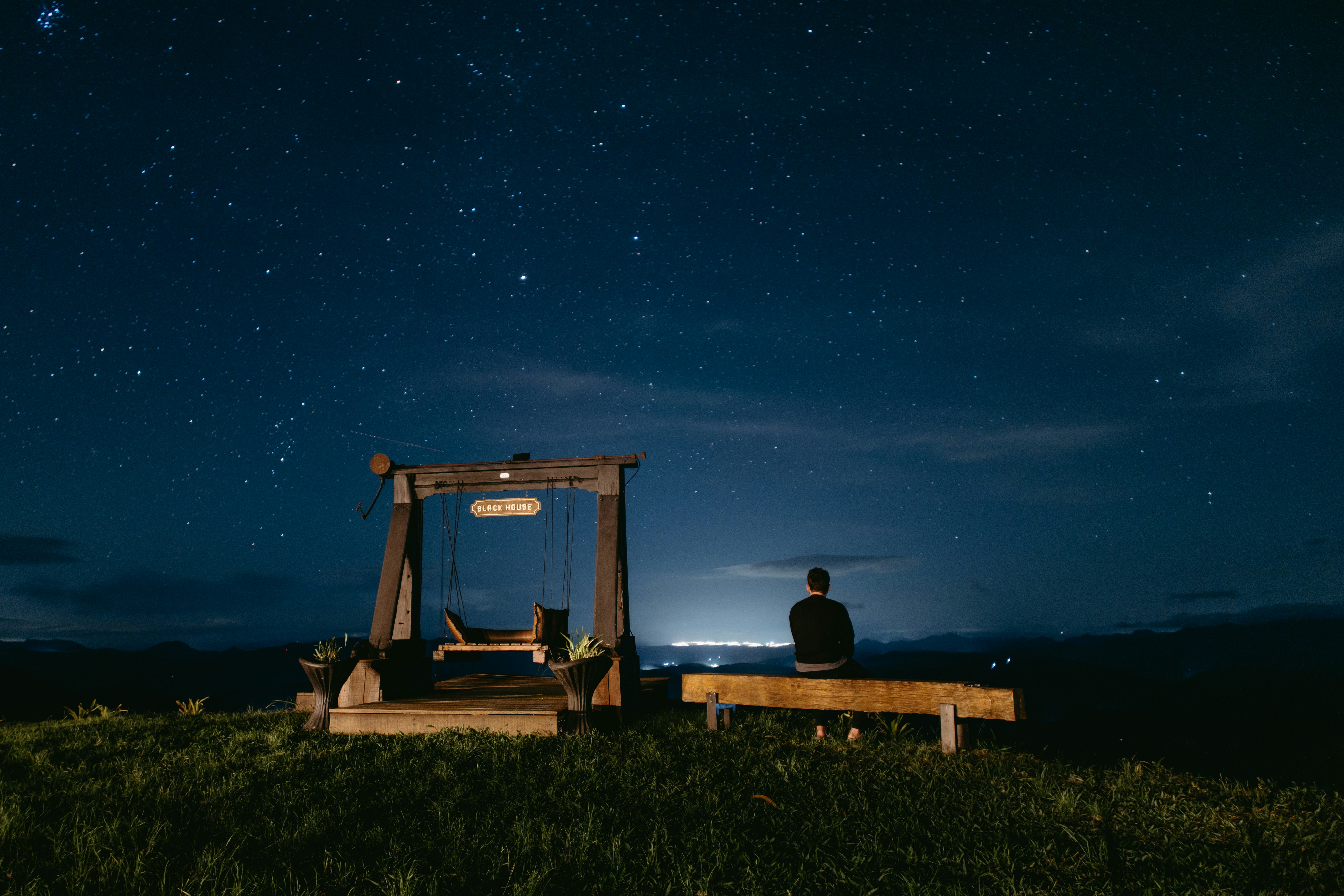 Man meditating under night sky