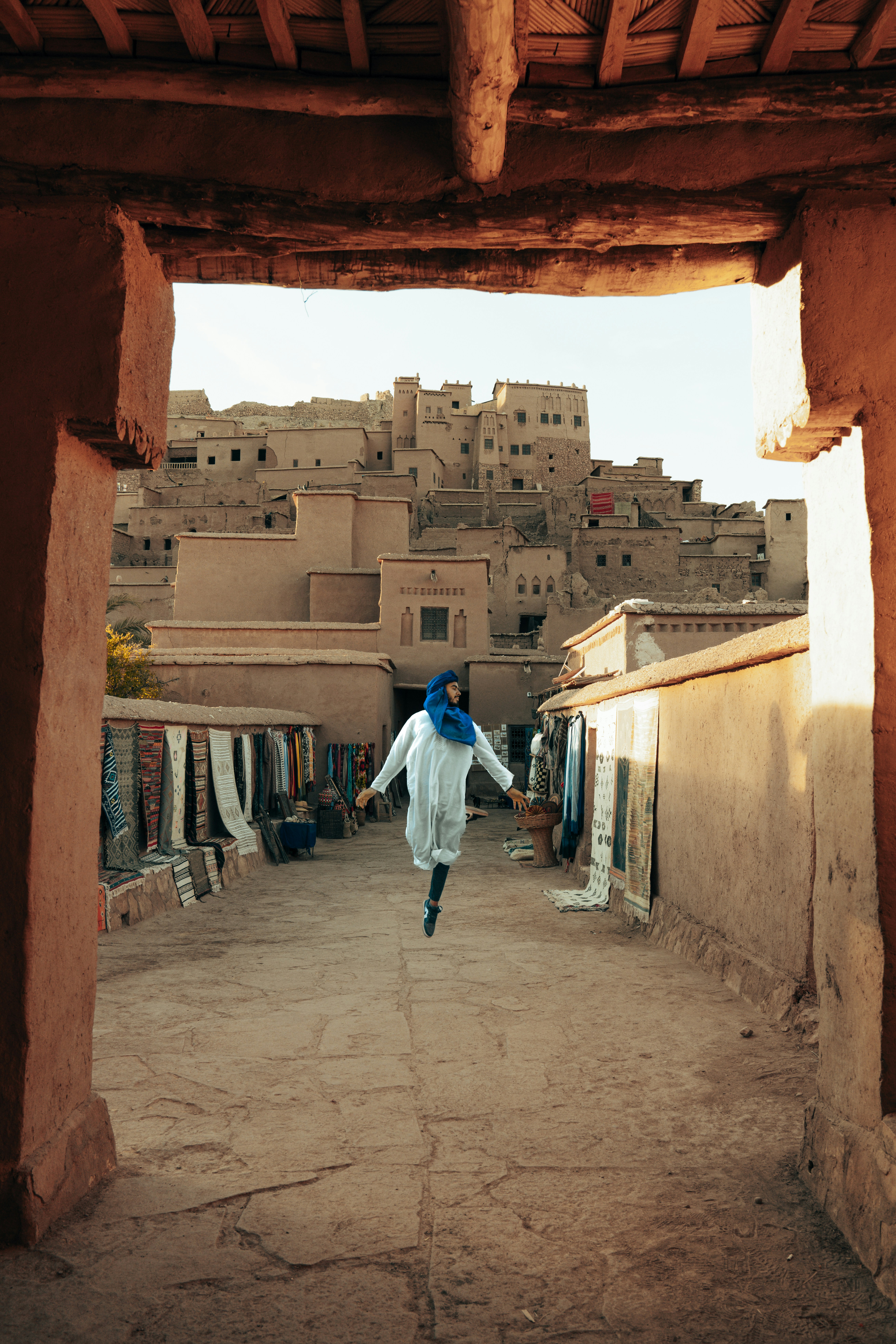 A woman walking down a street in a village
