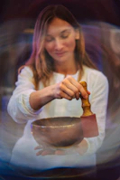 A woman mixing a bowl with a wooden spoon