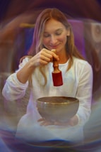 A woman mixing a bowl with a red mixer