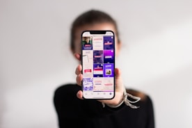 A person holding a cell phone up to their face