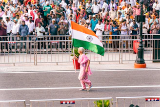 A woman walking down a street holding a flag