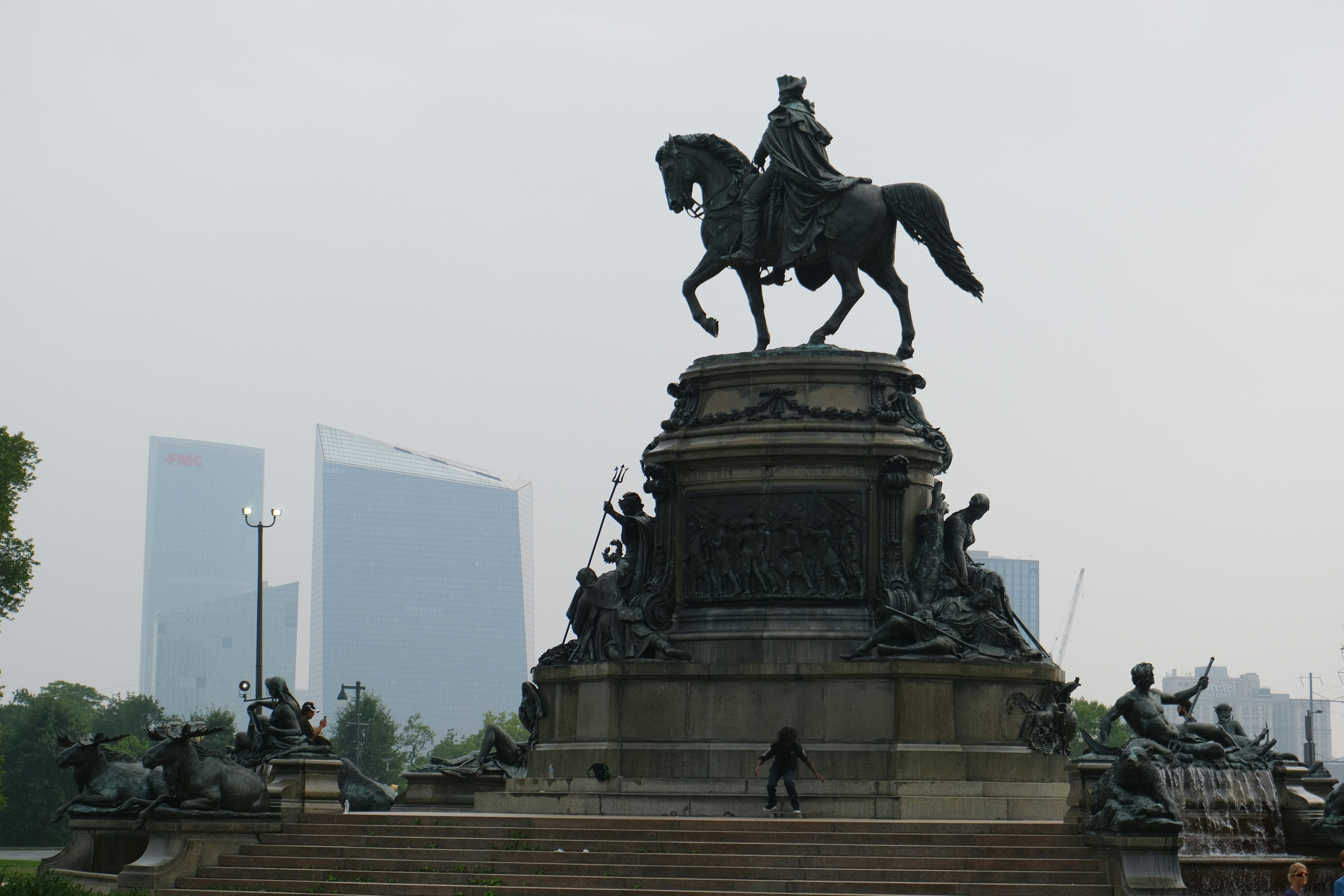 A statue of a man on a horse in a park