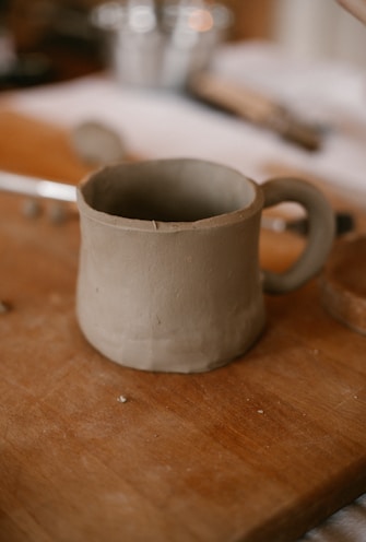 A cup sitting on top of a wooden table