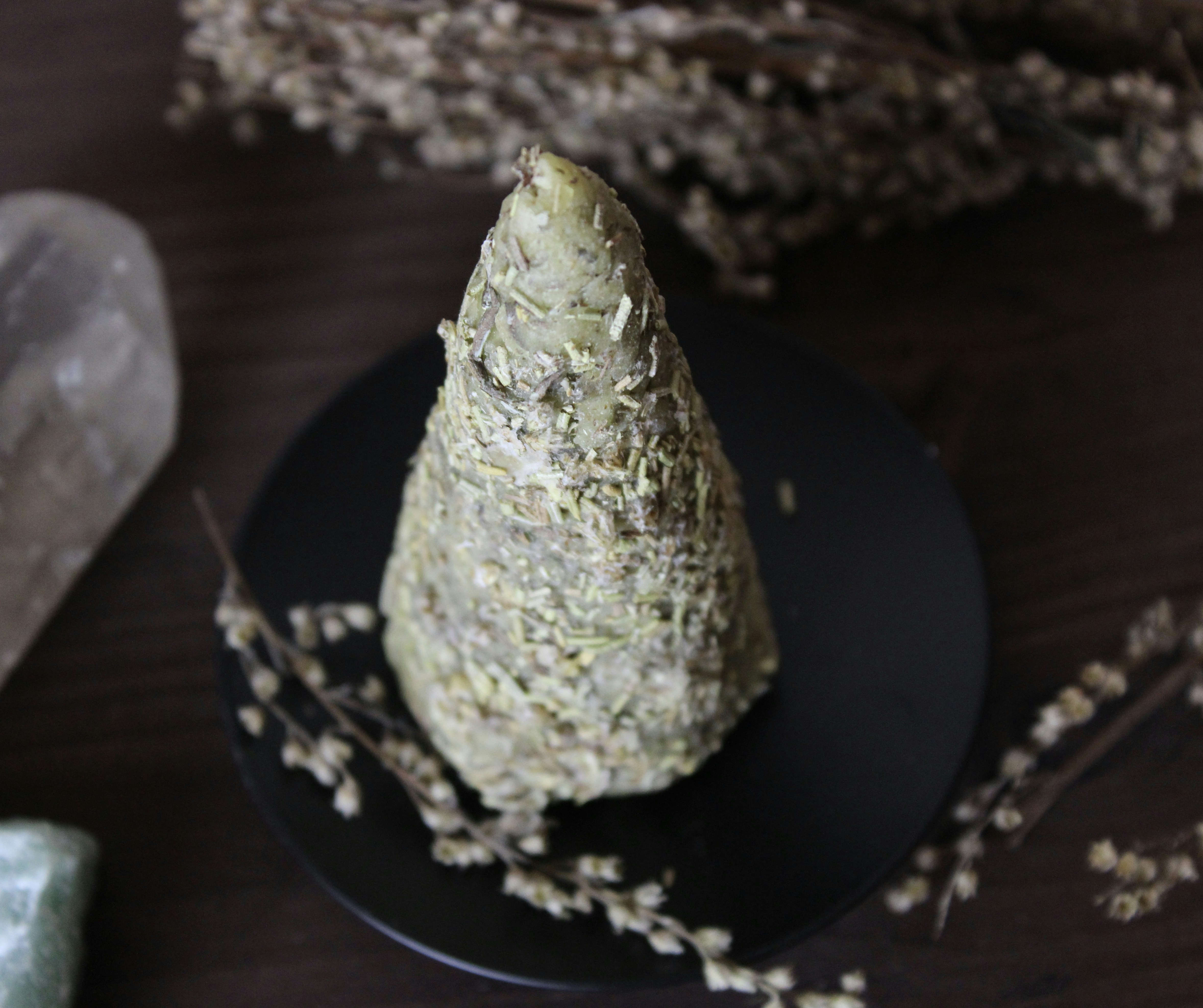 A black plate topped with a piece of food