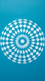 A blue wall with a white circular design on it