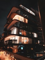 A very tall building with lots of windows at night