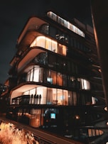 A very tall building with lots of windows at night