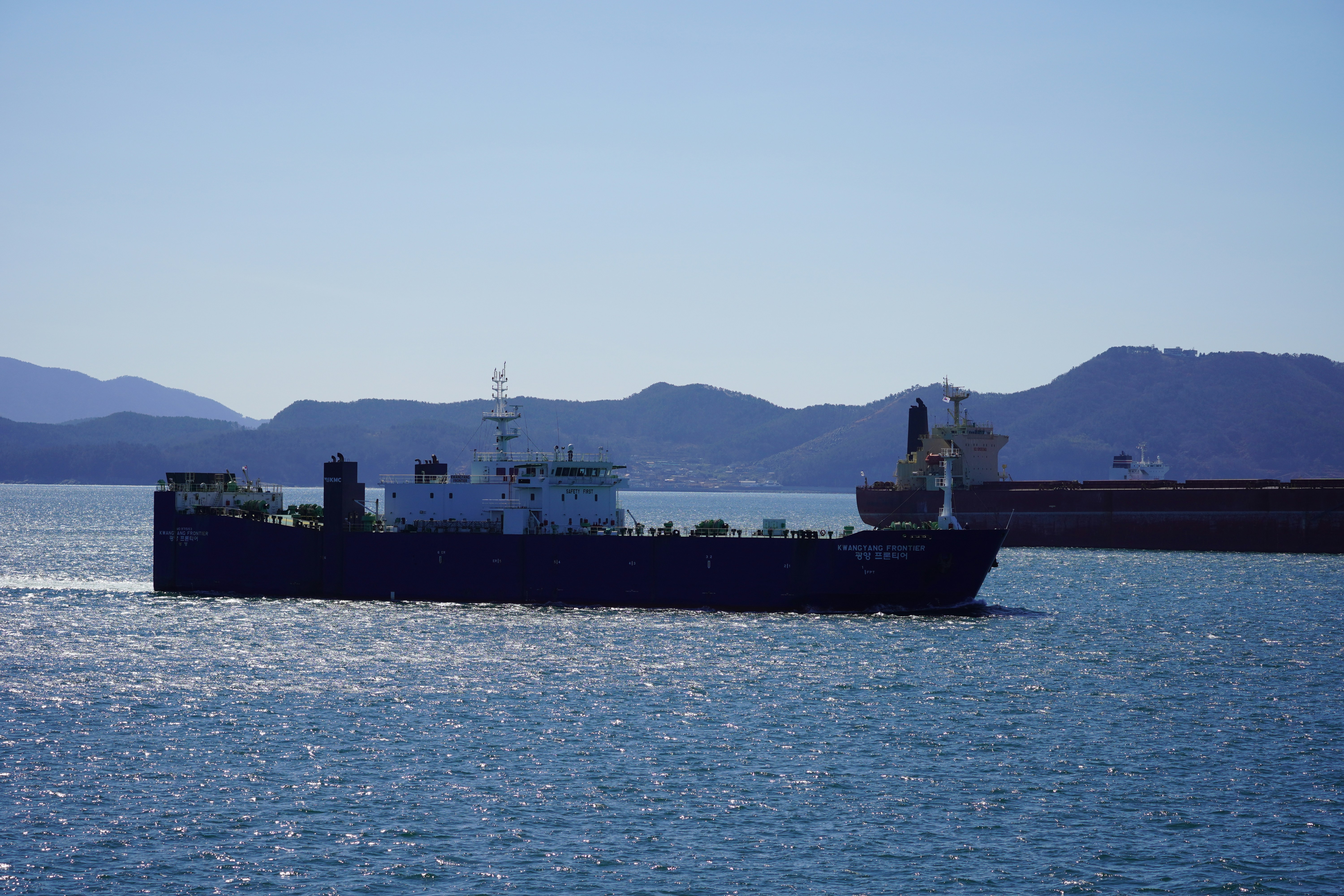 A large boat floating on top of a large body of water
