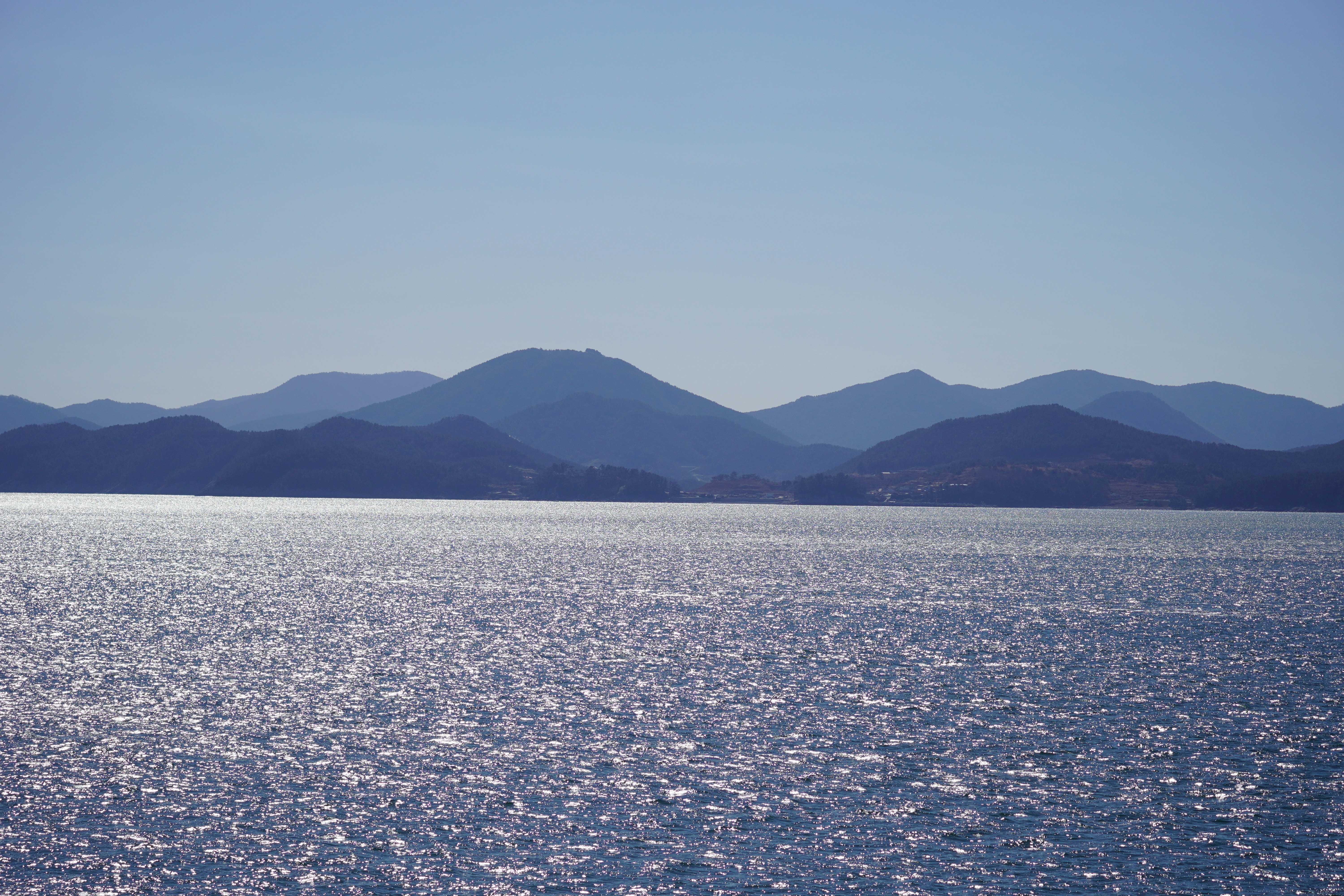 A large body of water with mountains in the background