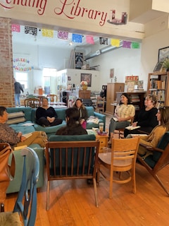A group of people sitting around in a library