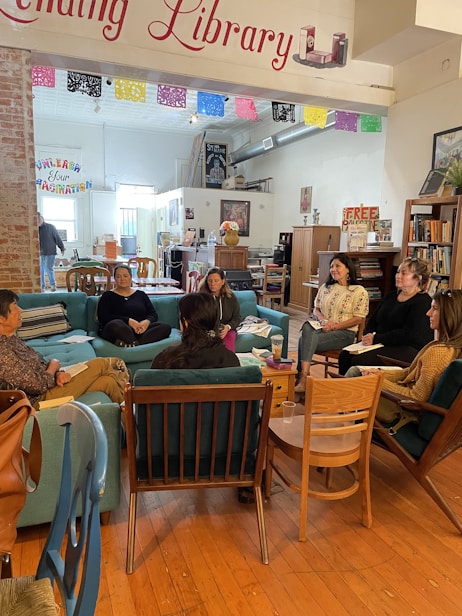 A group of people sitting around in a library