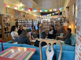 A group of people sitting at tables in a library