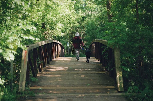 A man riding a bike down a wooden bridge
