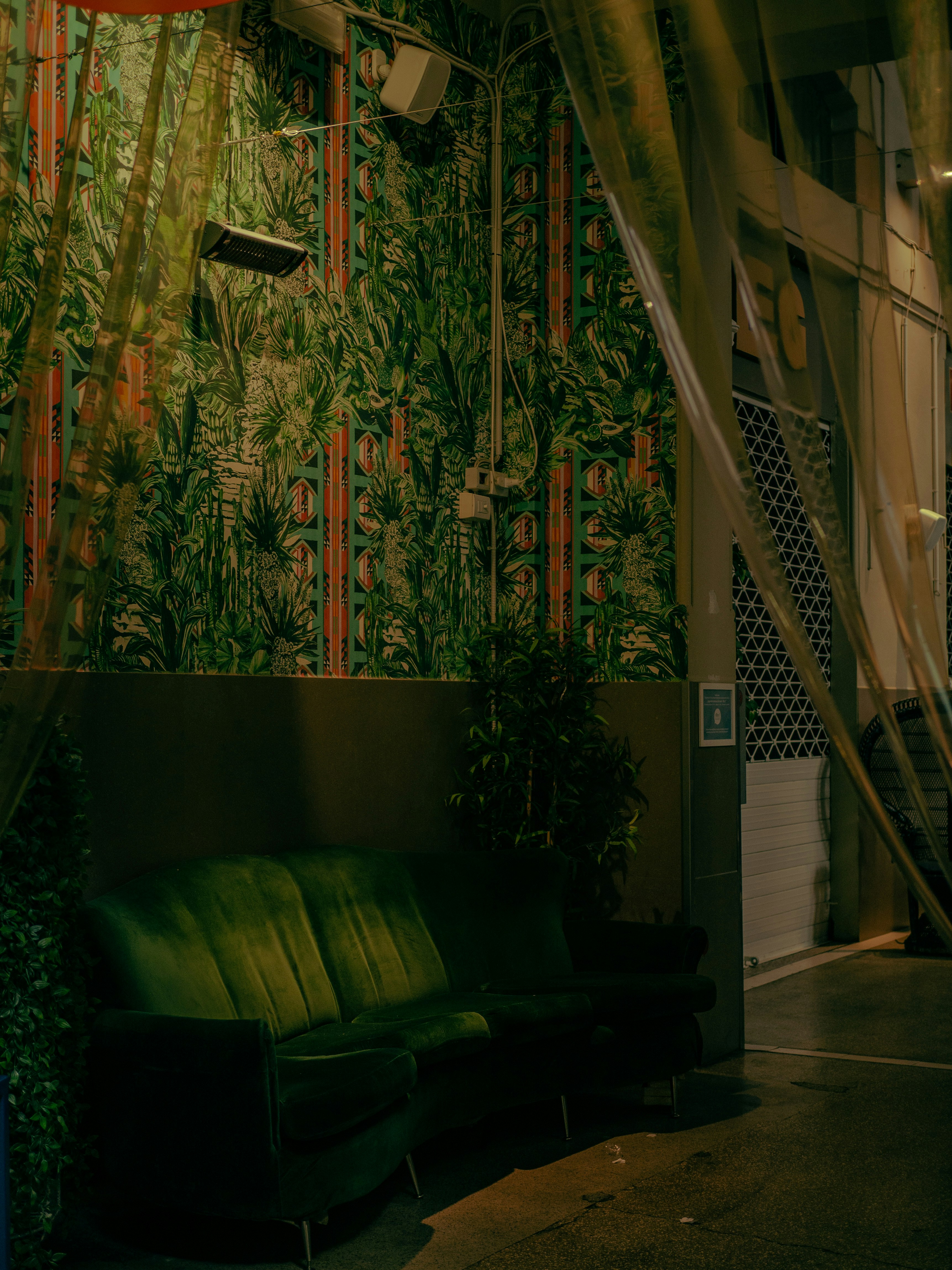 A room with a green couch and a green chair