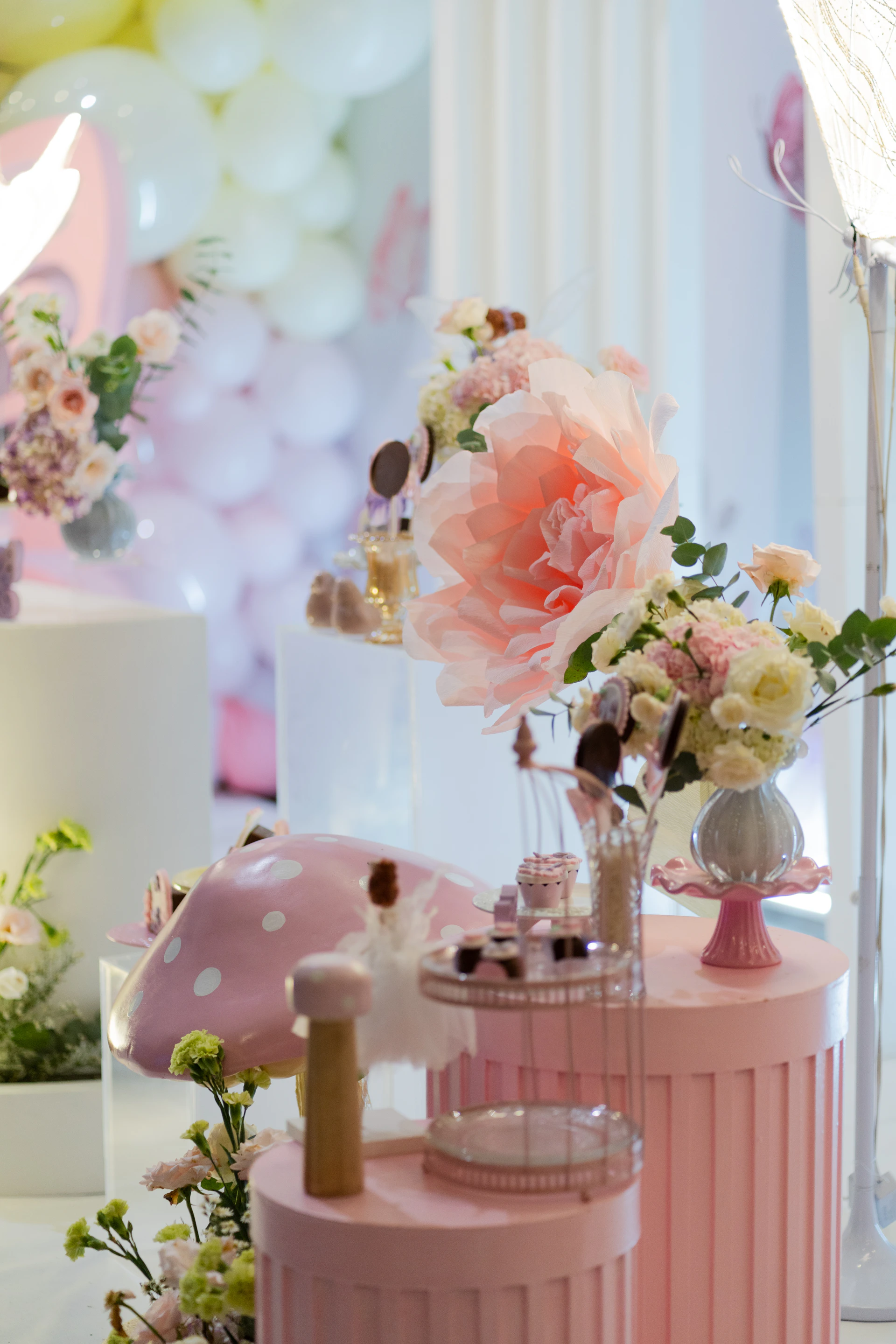 A table topped with lots of vases filled with flowers