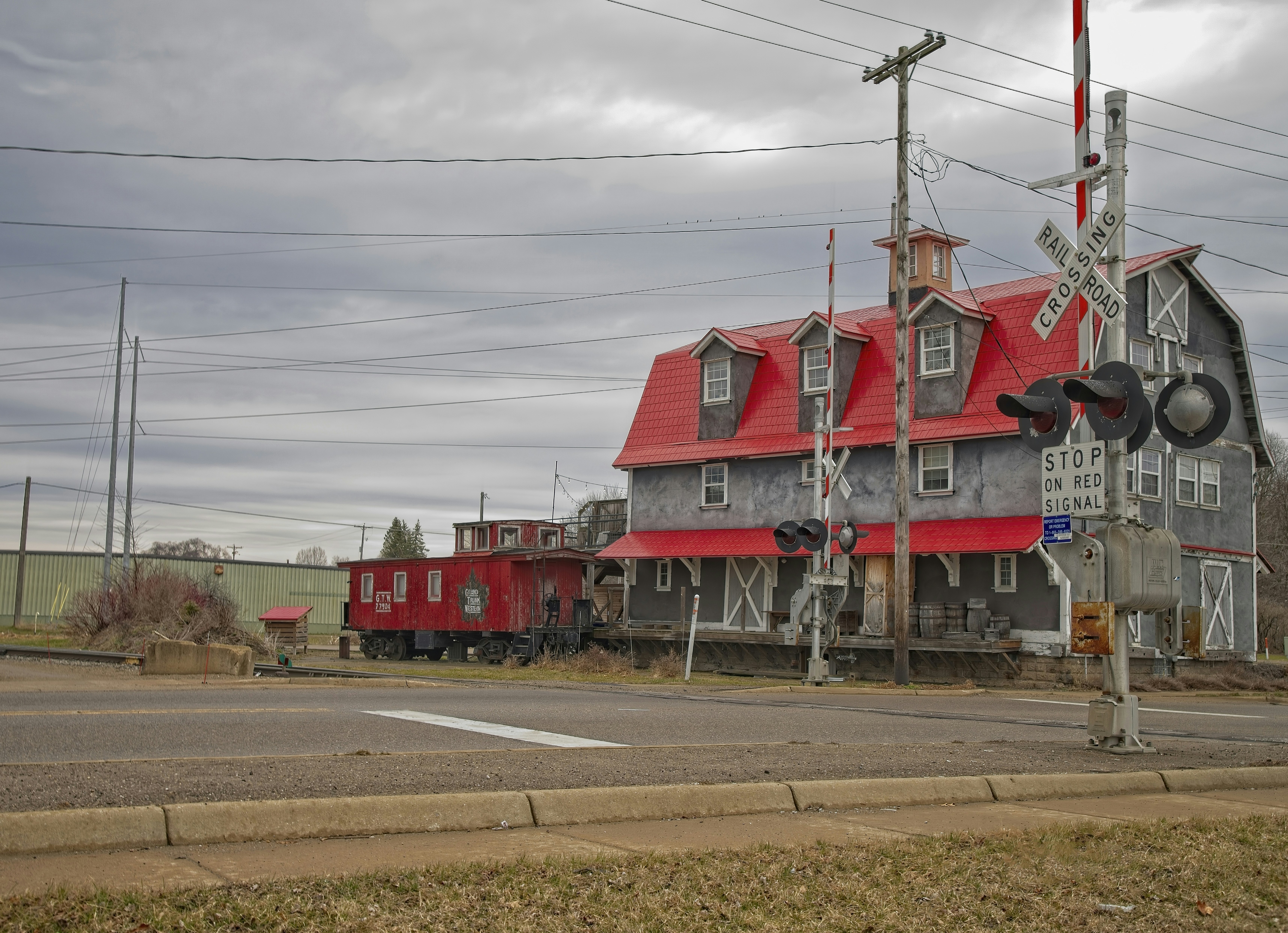 A red and gray building with a red roof