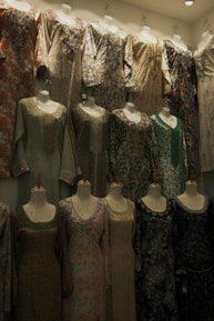 A room filled with lots of mannequins and dresses
