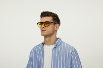 A man wearing sunglasses and a blue shirt