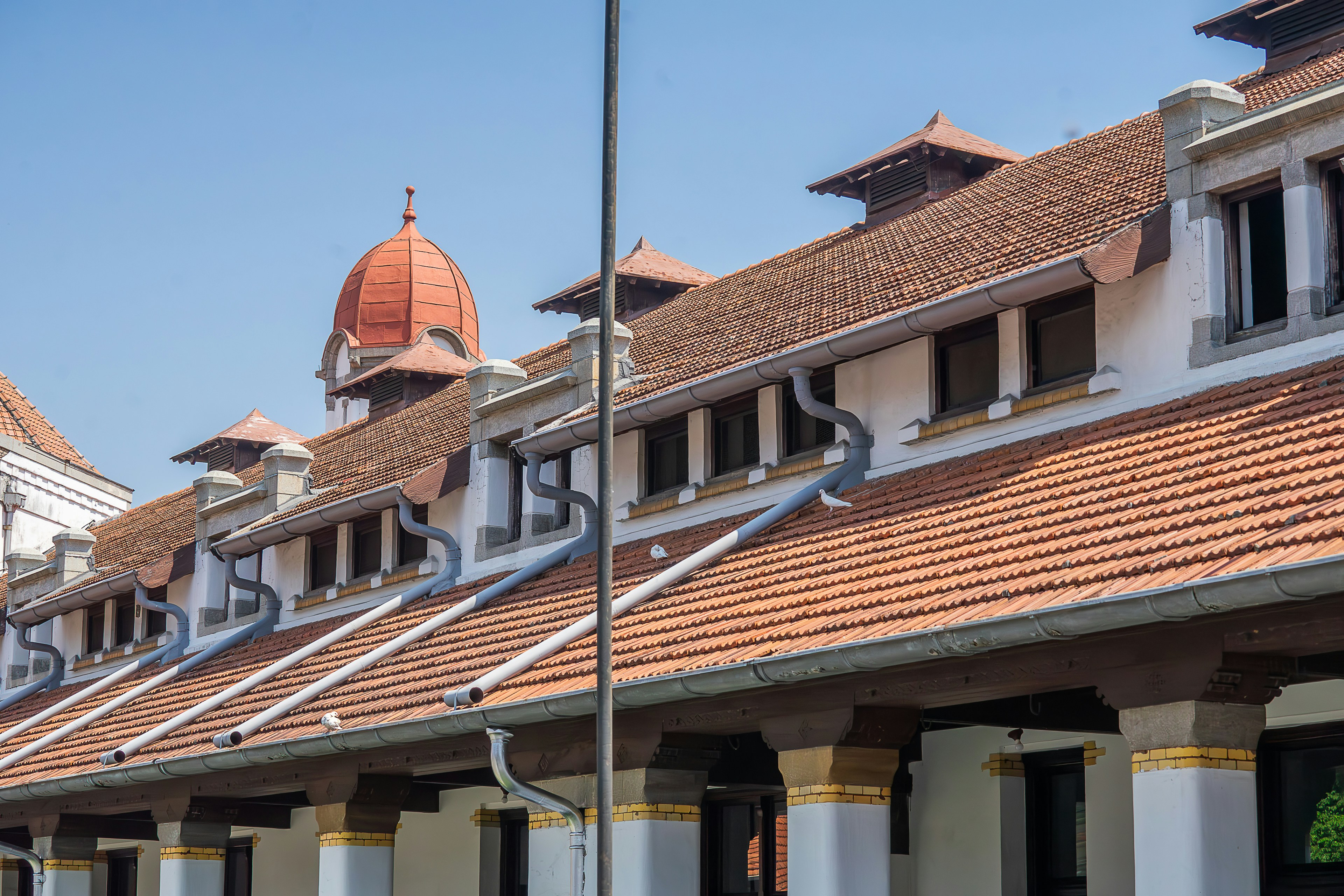A row of buildings with a clock tower in the background