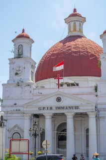 A large white building with a red dome