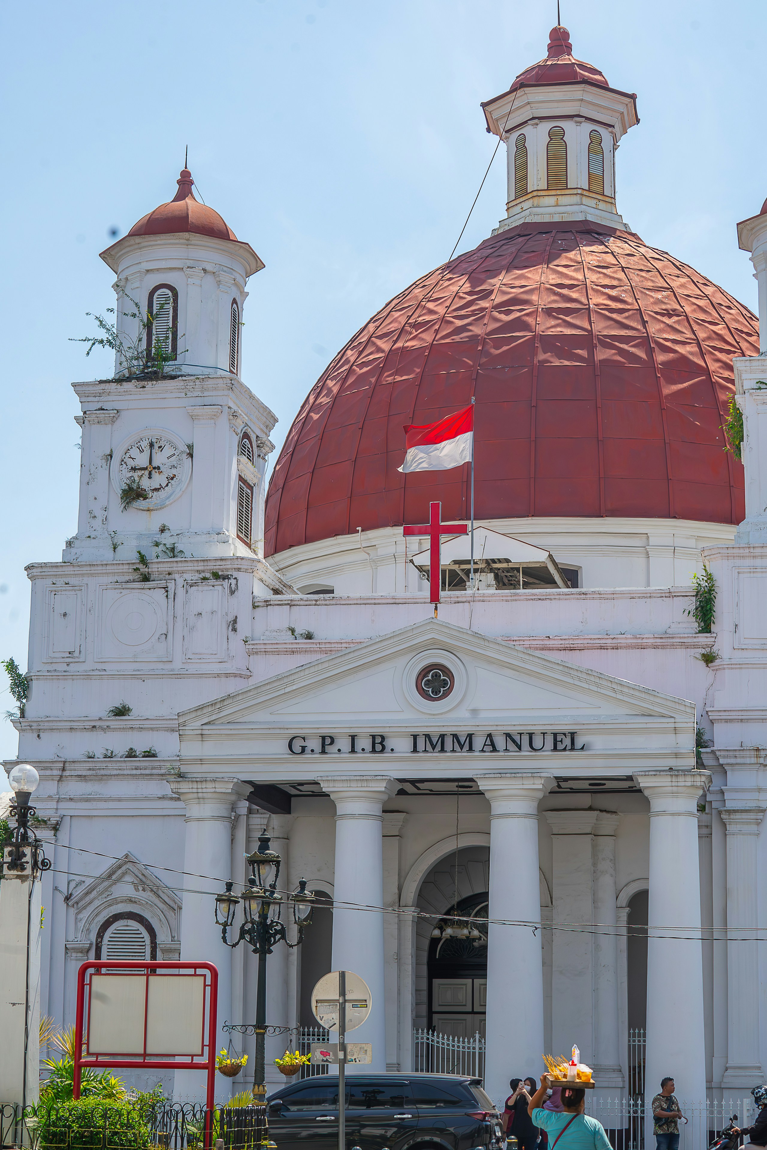 A large white building with a red dome