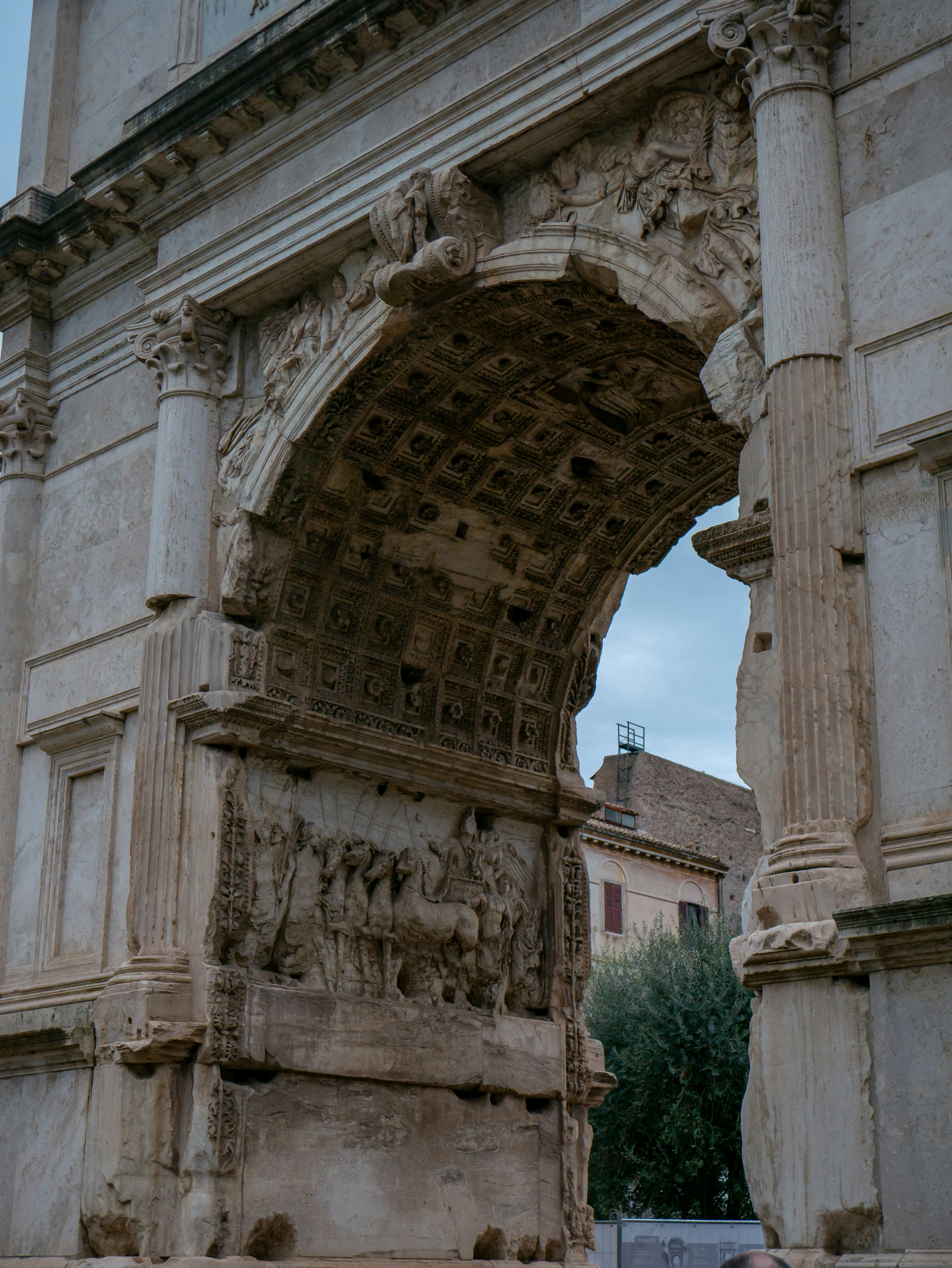 A stone arch with a clock on top of it
