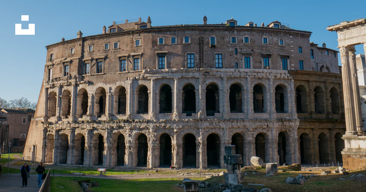 Building With Ramon Statue A large building that is in the middle of a field photo – Free Roman ...