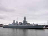 A large battleship sitting in the middle of a body of water