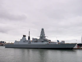 A large battleship sitting in the middle of a body of water