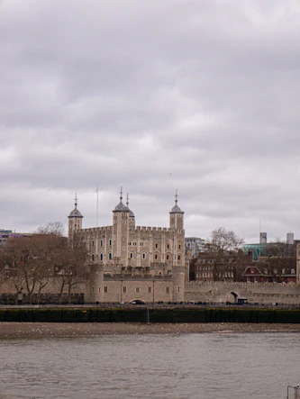 A large castle sitting next to a body of water