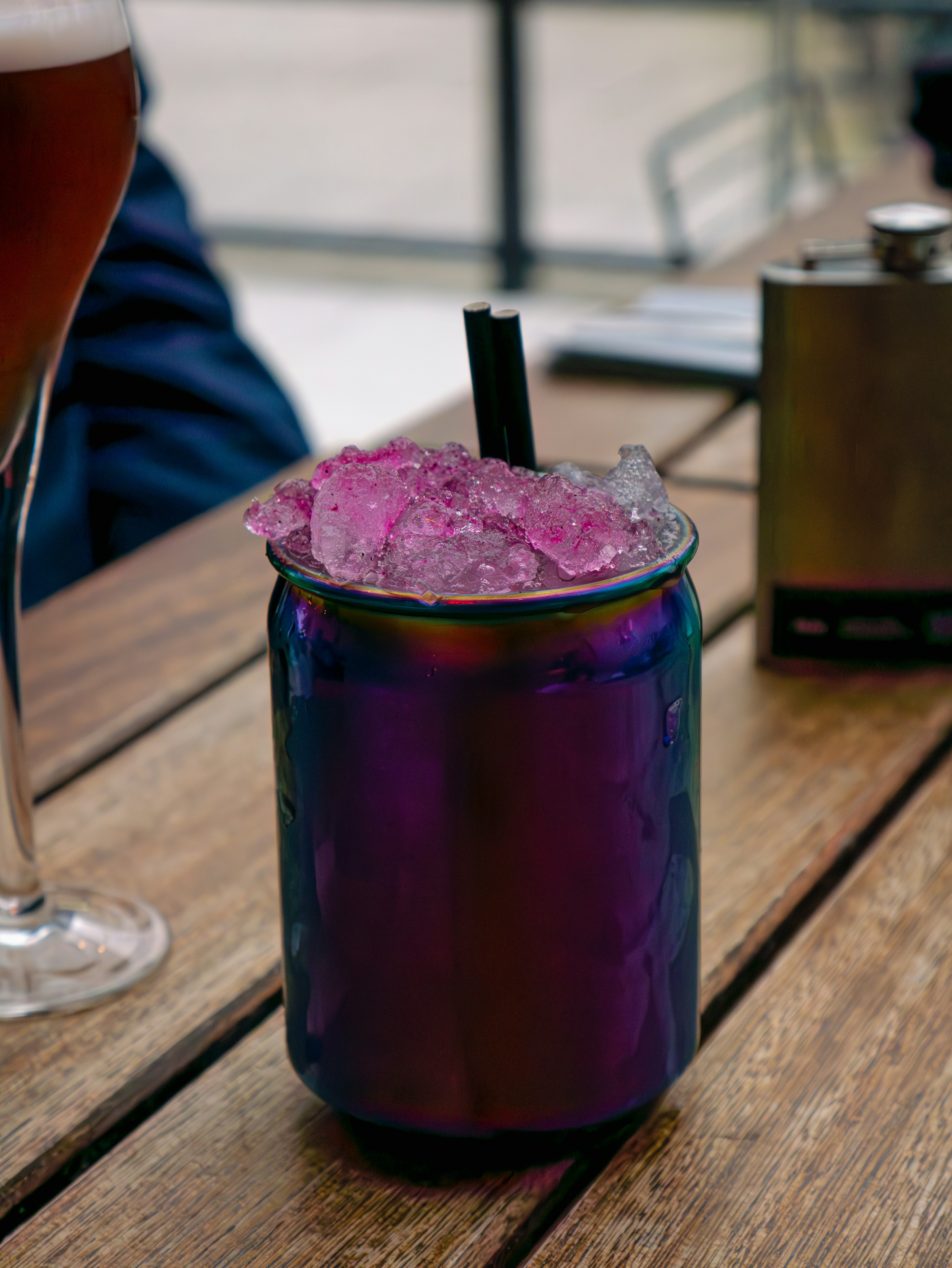 A purple drink sitting on top of a wooden table