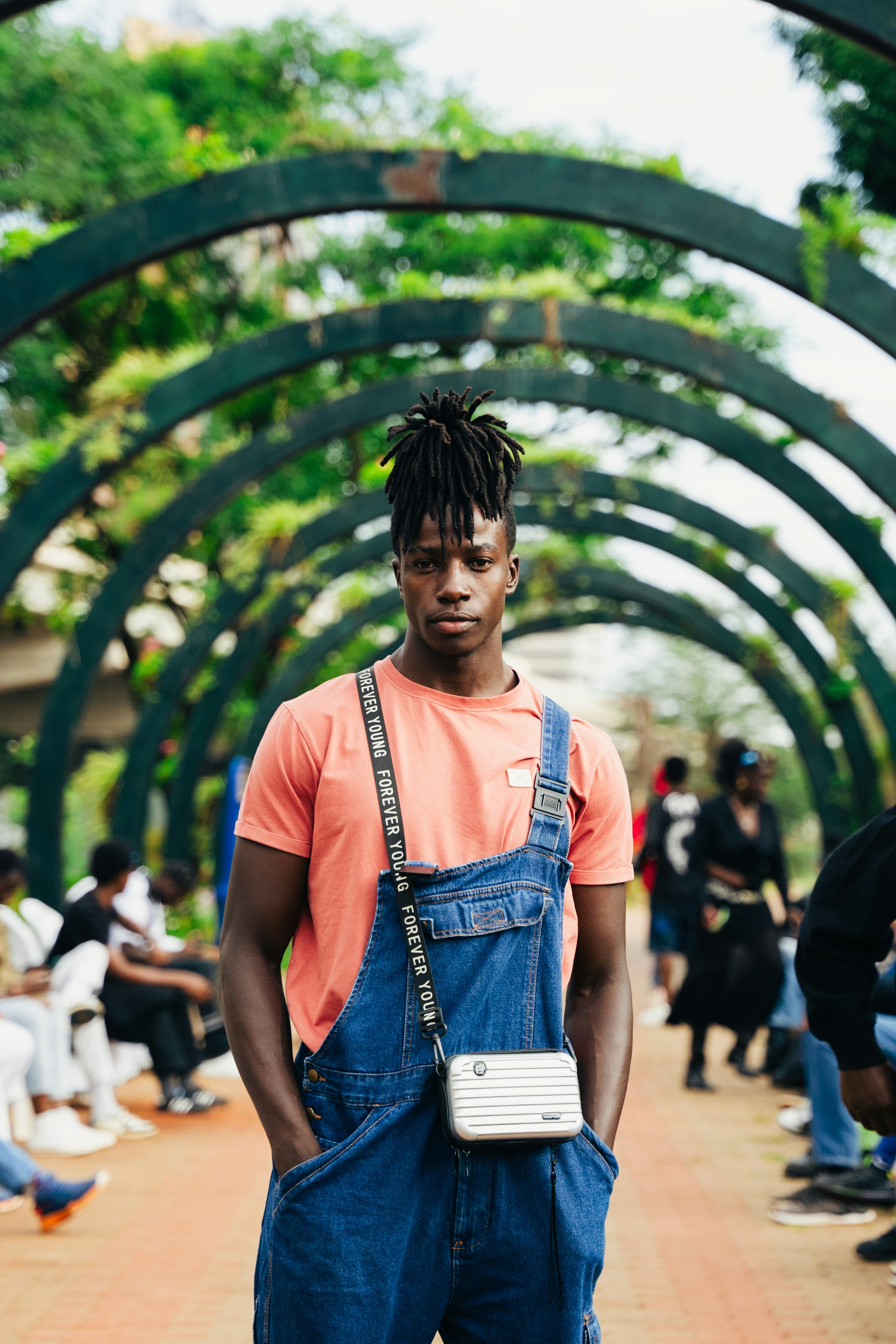 A man in overalls and an orange shirt