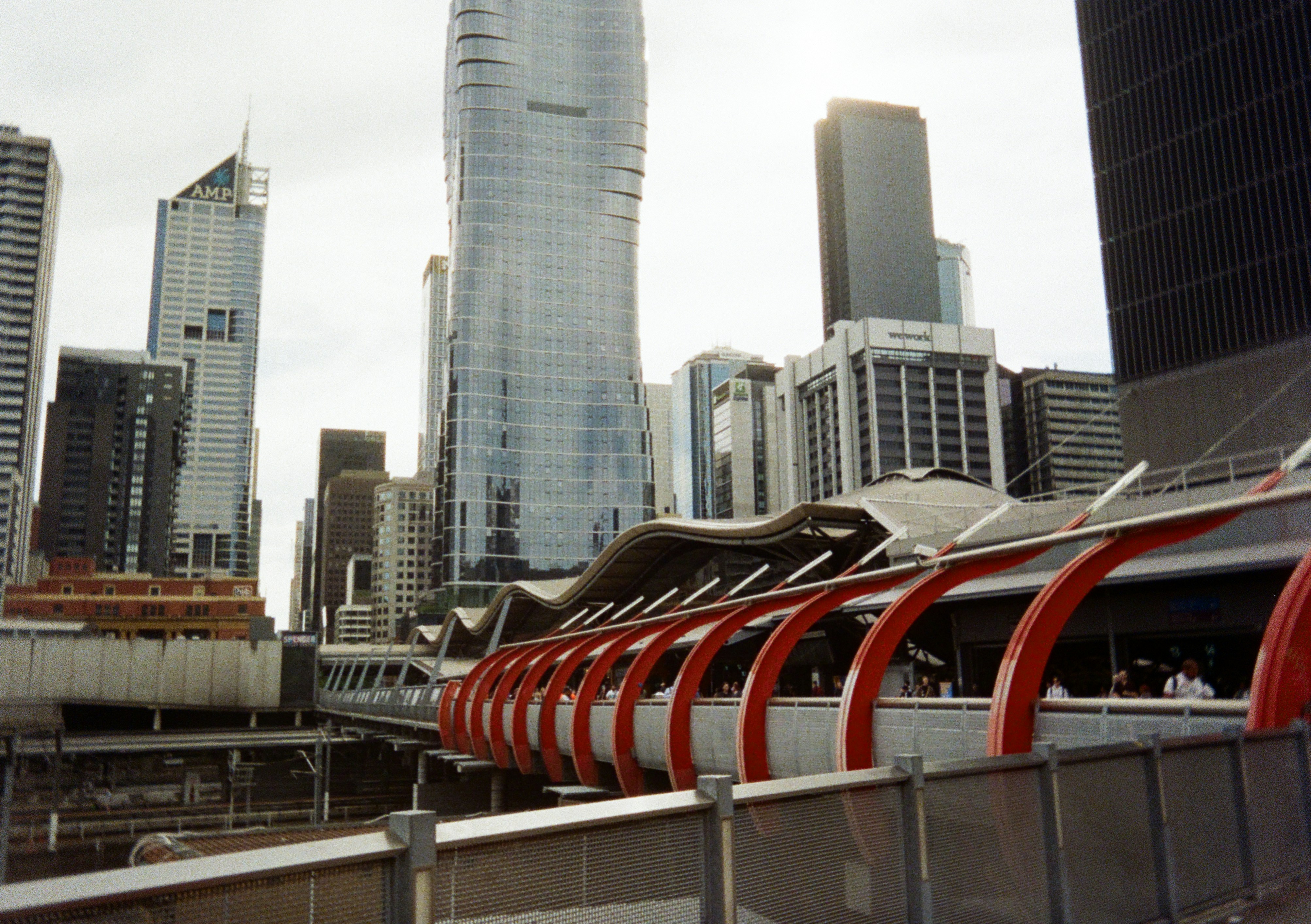 A train traveling through a city next to tall buildings photo – Free ...