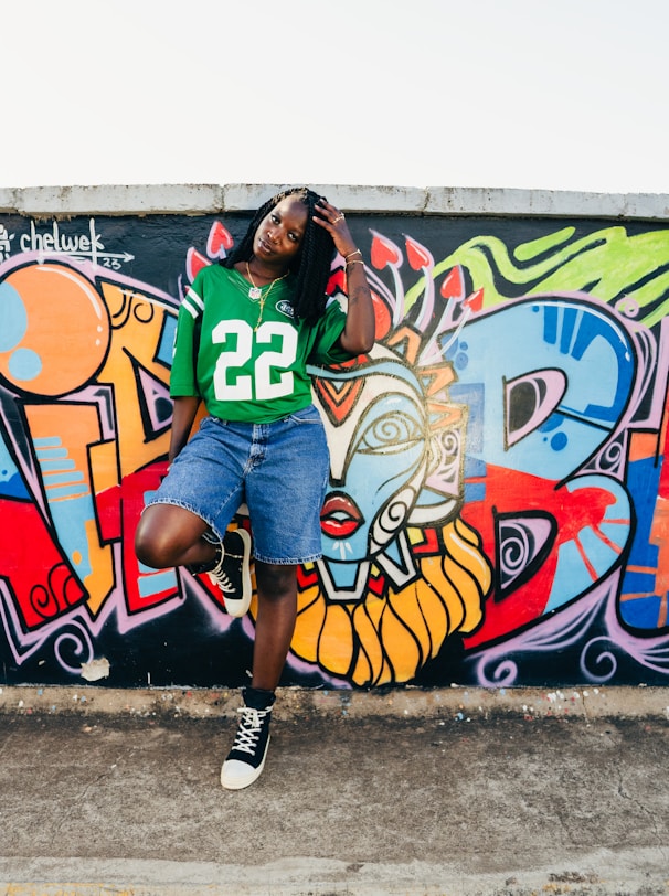 A woman standing in front of a wall covered in graffiti