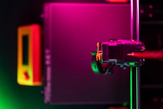 A person holding a camera in front of a monitor