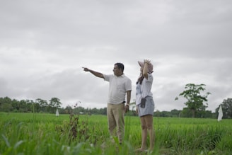 A man and a woman standing in a field