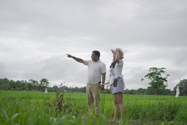 A man and a woman standing in a field