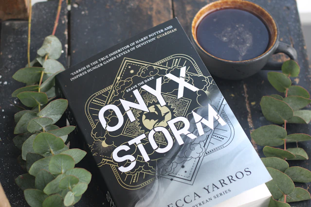 A book sitting on top of a table next to a cup of coffee