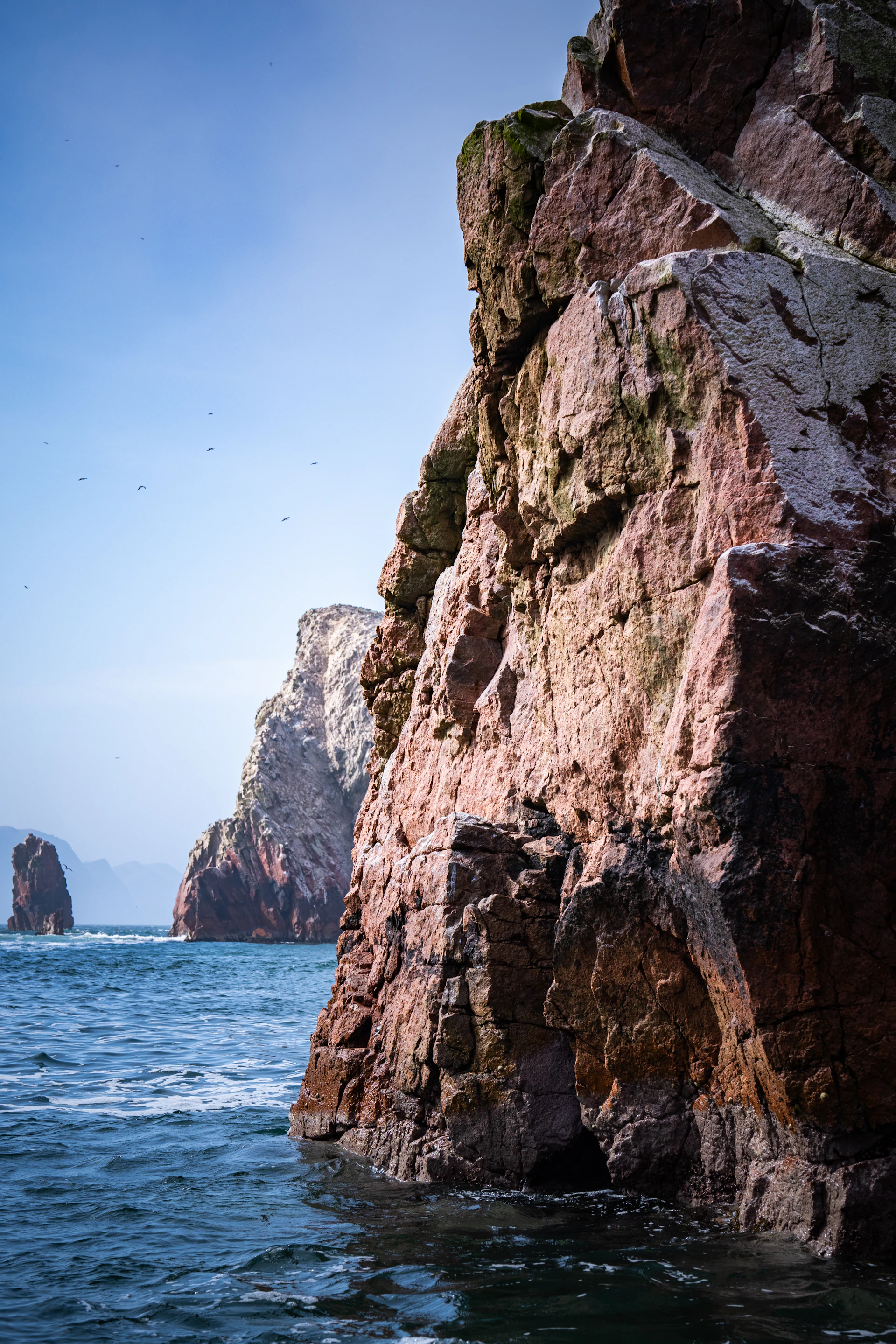 A large rock outcropping into the ocean