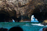 A group of people on a boat looking at icebergs