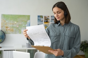 A woman holding a piece of paper in her hands
