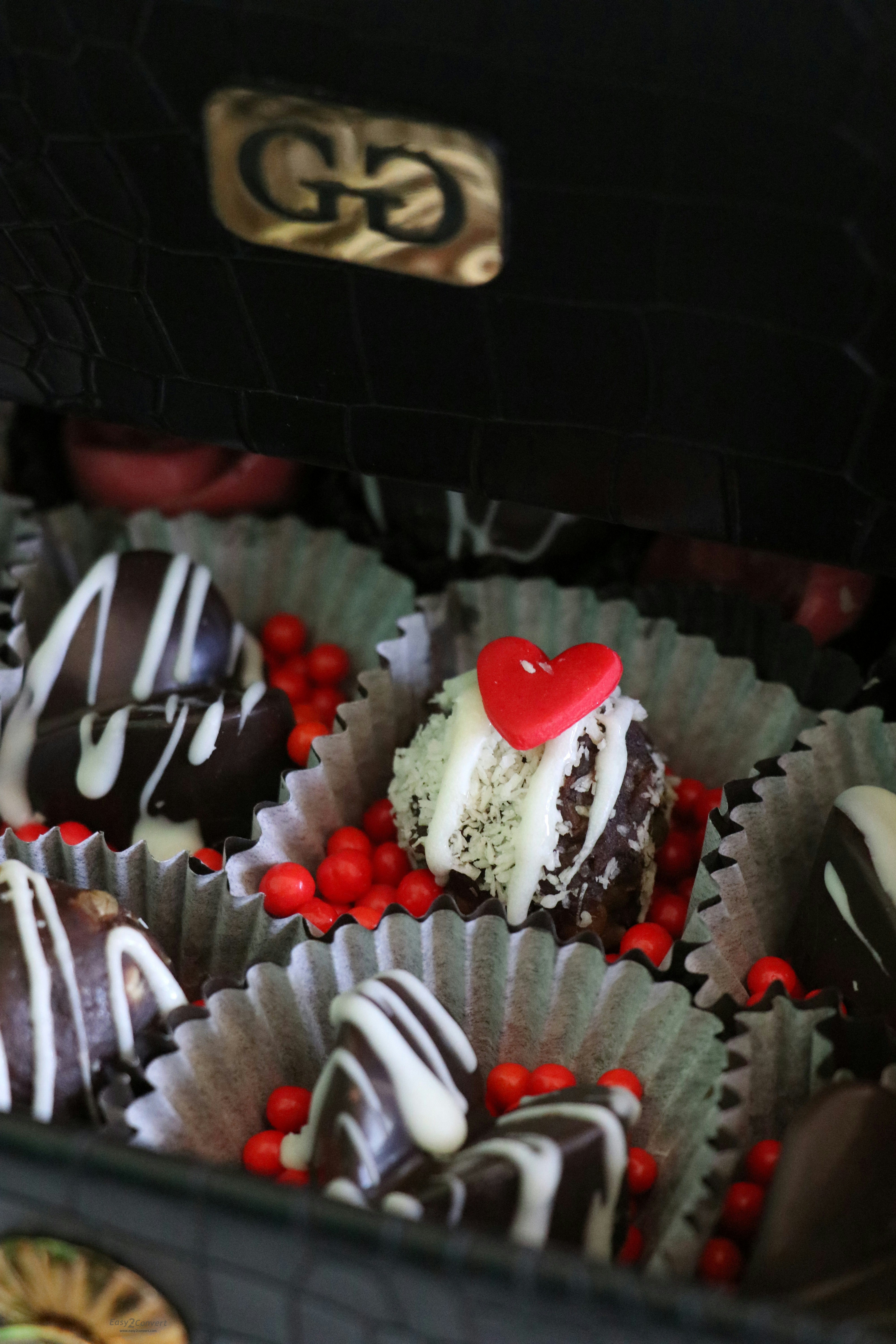 A box filled with lots of chocolate covered desserts